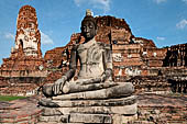 Ayutthaya, Thailand. Wat Mahathat, Buddha statue of the gallery enclosing the collapsed central prang.